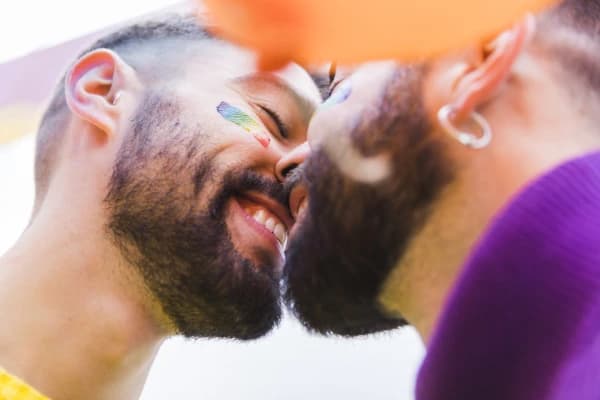 Gay couple kissing after meeting in an anonymous chat